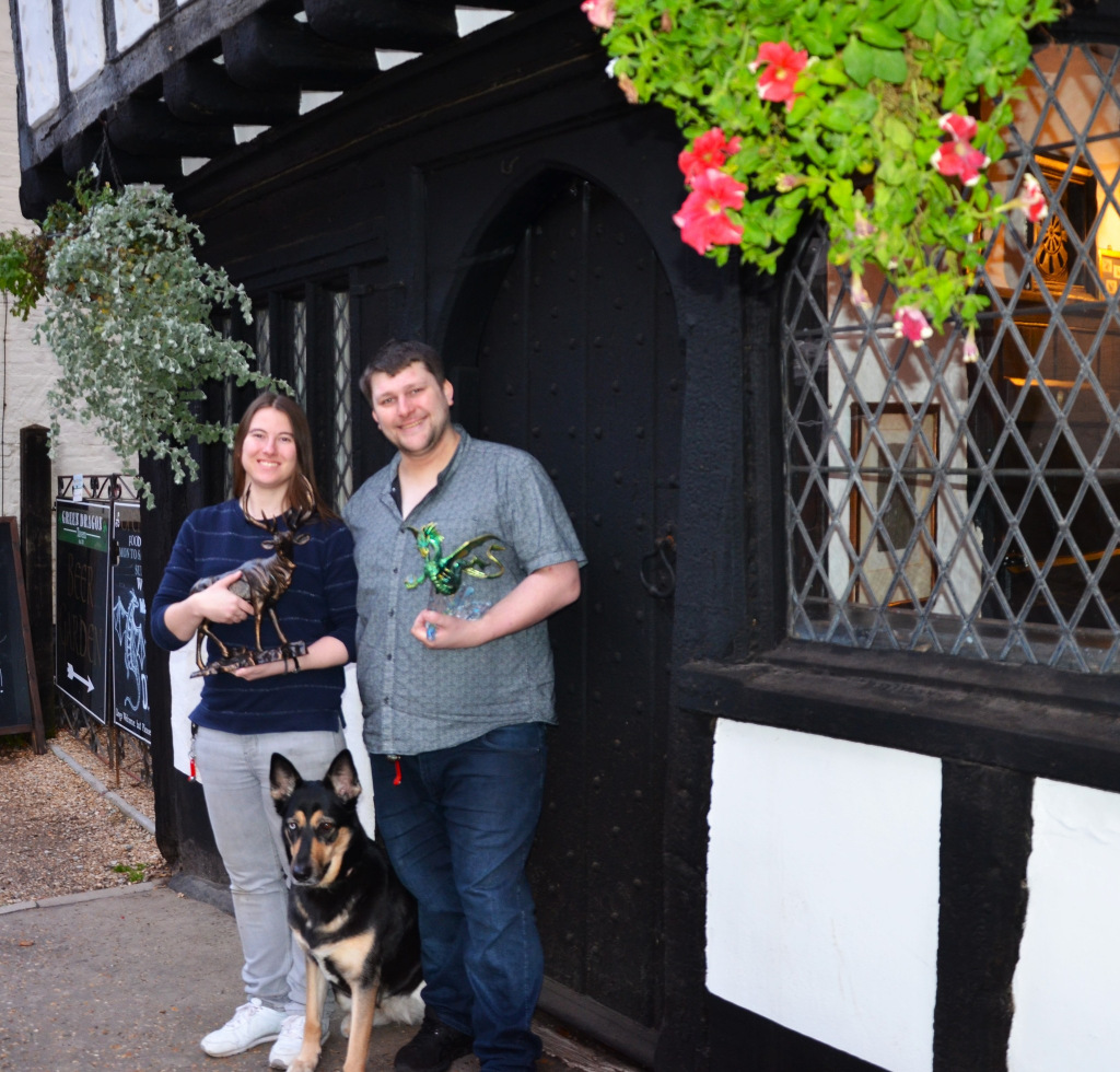 Man and woman with dog in front of pub
