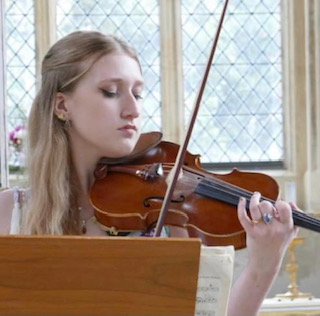 Young blonde woman playing violin