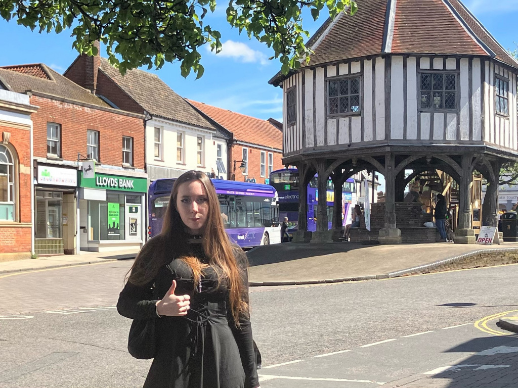Girl with thumb up in front of Market Cross